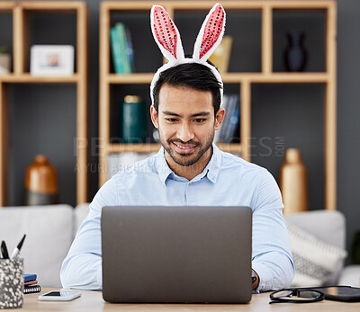 Buy stock photo Laptop, bunny ears and business man  in office with decoration for celebration, event and Easter party. Corporate, happy and Asian male person on computer at desk with rabbit headband for holiday