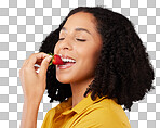 Woman, face and eating strawberry for natural nutrition, dieting or healthy food against a gray studio background. Happy female smiling and enjoying tasty organic fruit for health, diet or wellness