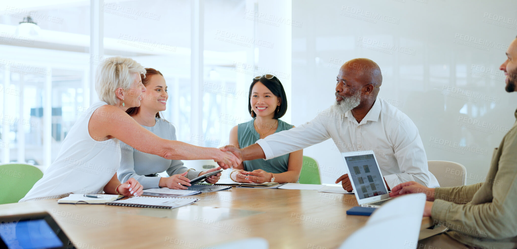 Buy stock photo Handshake, meeting and partnership with a business team in an office boardroom for deal or agreement. Thank you, collaboration and diversity with a male and female employee shaking hands at work