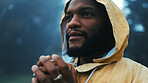 Coffee, morning and a black man hiking in nature with a blurred background of cold, winter weather. Thinking, raincoat and face with a young male hiker in the woods or forest to explore for adventure