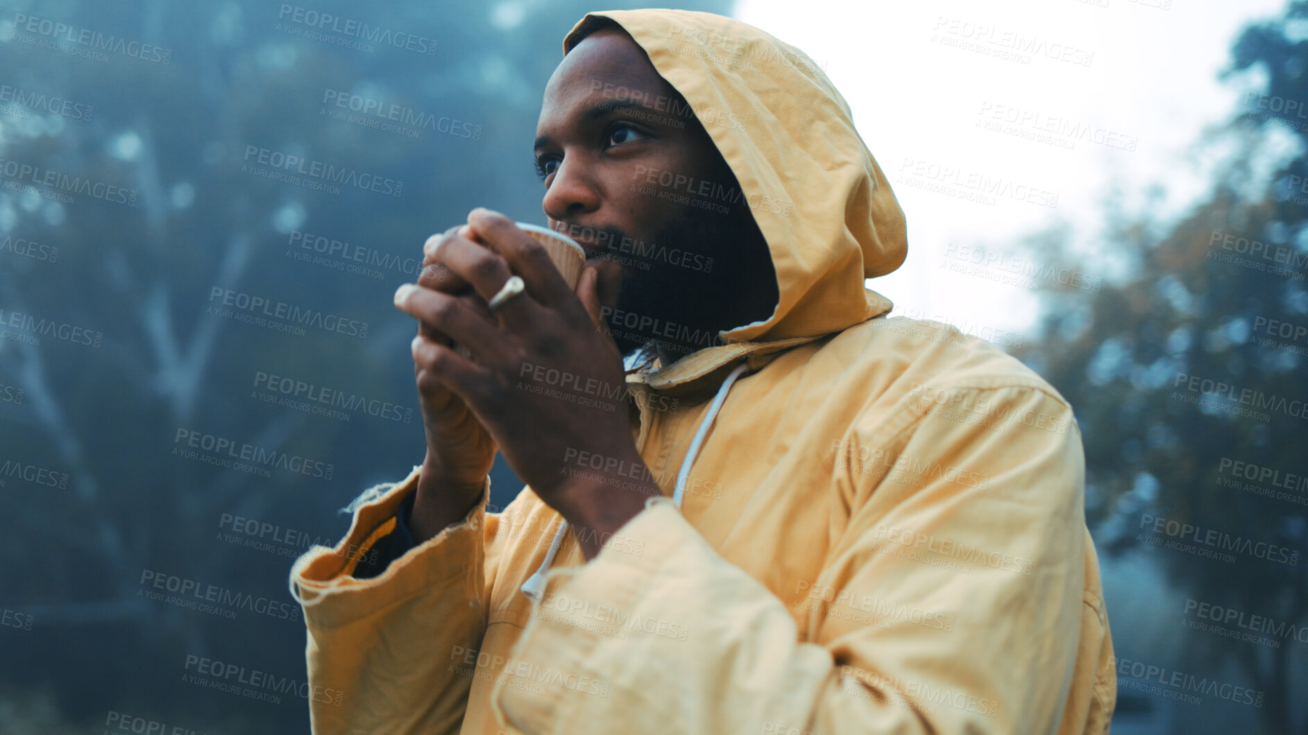 Buy stock photo Coffee, morning and black man camping in the forest for hiking, holiday or vacation in winter weather. Thinking, raincoat or face of a young male hiker in the woods or nature to explore for adventure