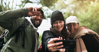 Friends, happy or hikers taking a selfie while hiking outdoors in nature sharing the experience on social media. Winter, forest or active people take a picture or a photo while trekking together