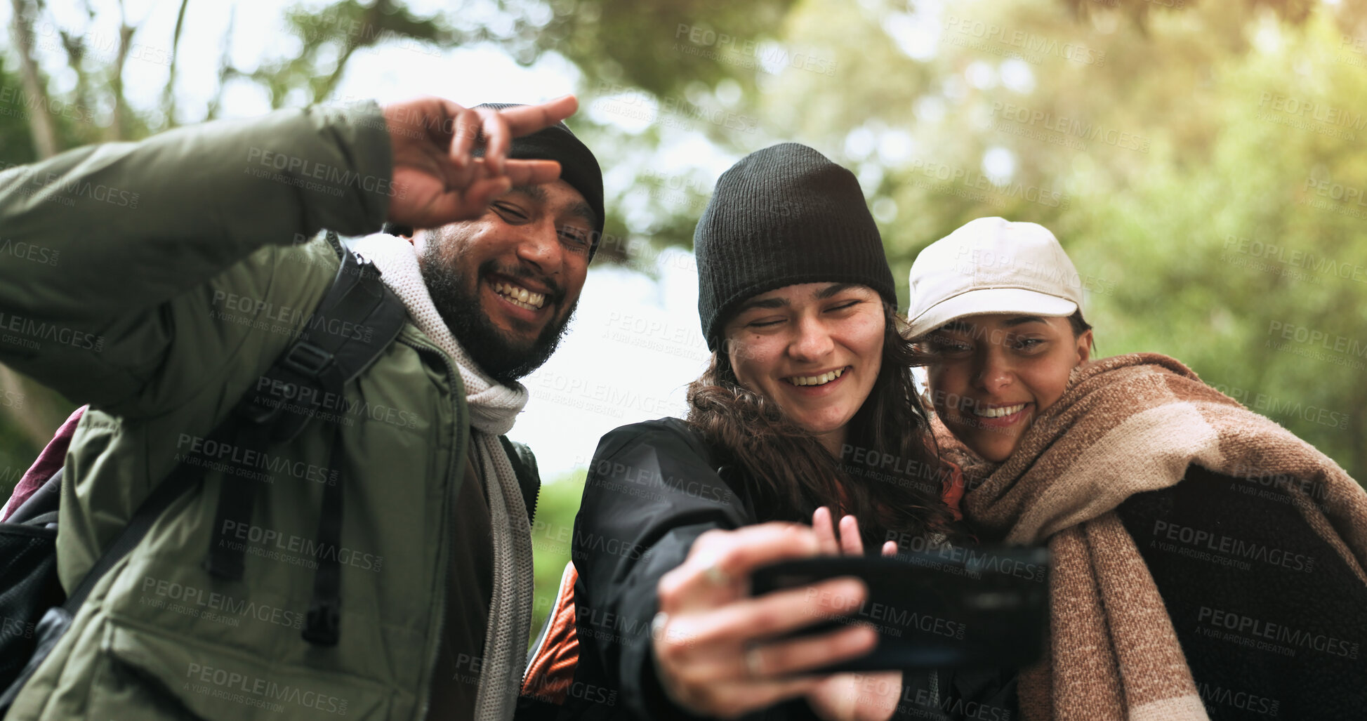 Buy stock photo Hiking, friends and selfie in a forest with peace hands, hug and smile while bonding outdoor. Phone, profile picture and group of people happy in a jungle for adventure, freedom and trekking fun