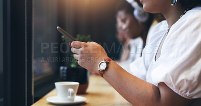 Cafe, phone and closeup of a woman typing a text message on the internet or social media. Technology, cup of coffee and young female person doing research or browsing on her cellphone in a restaurant