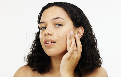 Buy stock photo Face, beauty and makeup with a woman in studio isolated on a white background touching her skin. Portrait, skincare and facial with an attractive young female rubbing her cheek for natural treatment