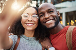 Selfie, freedom and smile with an interracial couple in the city together for travel, tourism or adventure overseas. Portrait, love or fun with a man and woman taking a photograph in an urban town