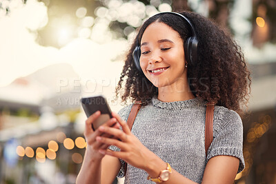 Buy stock photo City, headphones and woman with smartphone, typing and connection with happiness, social media and streaming music. Outdoor, female person and girl with a cellphone, contact and headset with audio