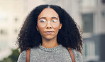 Serious, confident and portrait of a woman in the city with glasses for eye care or vision. Beautiful, young and headshot of young female person from Mexico exploring an urban town street for travel.
