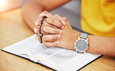 Prayer, worship and bible with hands of person in living room for peace, spiritual and Christian. Hope, God and belief with closeup of man with holy book at home for religion, praying and gratitude
