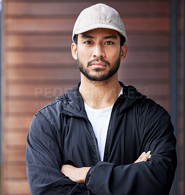 Buy stock photo Courier man, outdoor portrait and arms crossed for service, delivery and ready for supply chain. Young logistics worker, serious face and city for customer satisfaction, commerce and distribution job