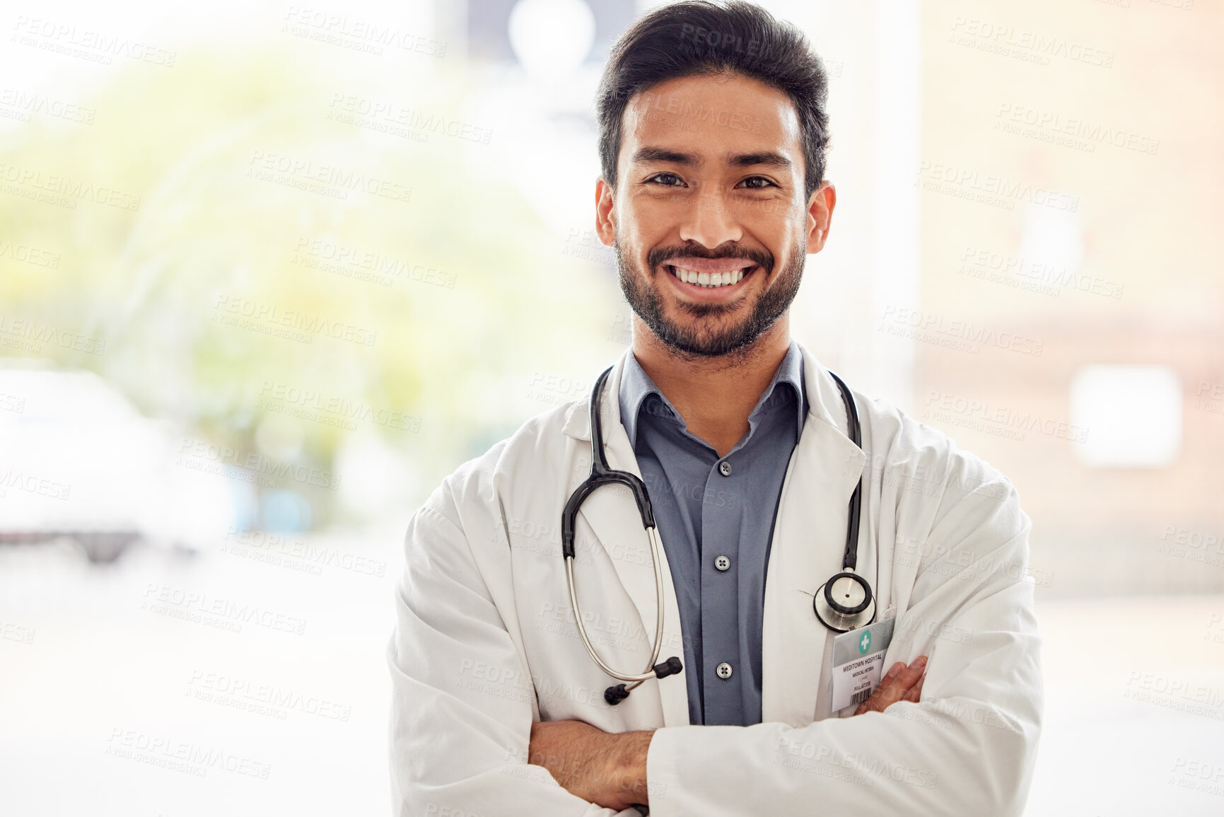 Buy stock photo Smile, portrait and asian man doctor with arms crossed in hospital for consulting, exam and help on blurred background. Happy, face and guy healthcare expert proud of service while working at clinic 