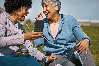 Buy stock photo Music, fitness and senior friends laughing on the grass outdoor taking a break from their workout routine. Exercise, training and funny with elderly people streaming audio on a field for wellness