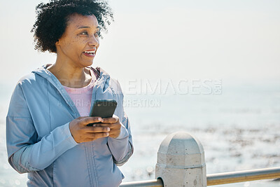Buy stock photo Running, phone and fitness with black woman at beach for relax, workout and social media. Network, communication and contact with female runner training in nature for technology, sports or mobile app