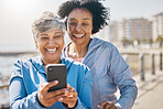 Senior woman, daughter and outdoor with phone or reading social media, blog or post about workout or walk in the park. Elderly mother, girl and profile picture on the beach or together on screen
