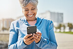 Fitness, outdoor and senior woman with cellphone, typing and social media with connection, network and happiness. Happy person, pensioner and old lady with a smartphone, smile and contact with health