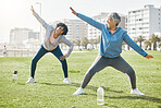 Women, senior and stretching in park, laugh with fitness and wellness, flexibility and start workout outdoor. Female people, friends warm up together and comedy with training and exercise in nature