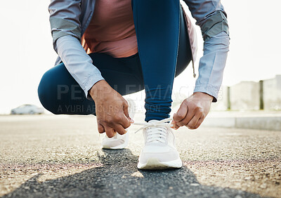 Buy stock photo Fitness, closeup and woman tie shoes outdoor in the road for running workout in the city. Sports, health and zoom of female athlete tying her laces for cardio exercise for race or marathon training.