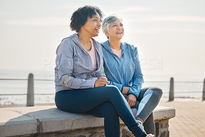 Buy stock photo Senior women, sitting and beach with friends, training and laugh in summer outdoor. Exercise, break and mature female in the morning with funny joke and workout for wellness and health by sea