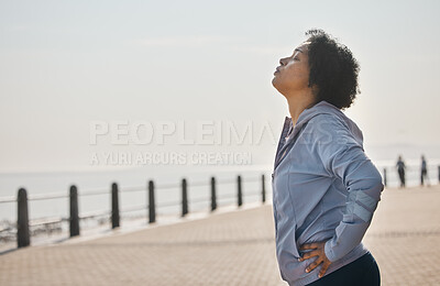 Buy stock photo Beach, tired and woman with fitness, sports and health with wellness, workout goals and running. Outdoor, female person or athlete breathing, exercise and mockup space with fatigue, ocean and profile