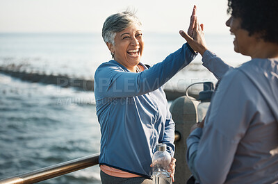 Buy stock photo High five, fitness and senior women friends at beach with exercise, celebration and excited in nature. Sport, people and elderly females with hands in support of wellness, training or success at sea