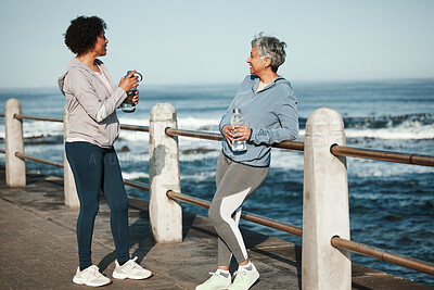 Buy stock photo Fitness, walking and senior women relax by ocean for healthy lifestyle, wellness and cardio on promenade. Sports, friends and female people talking on boardwalk for exercise, training and workout