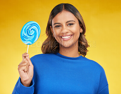 Buy stock photo Happy, candy and portrait of a woman, lollipop and positive girl on a yellow studio background. Face, female person or model with sweets, snack and fun with mockup space, cheerful or joy with freedom