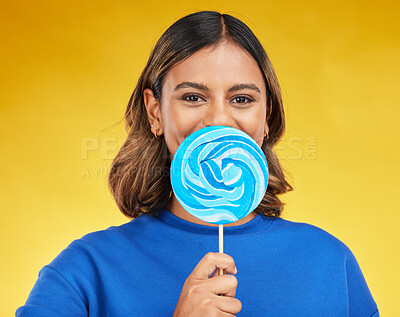 Buy stock photo Lollipop, candy and portrait of woman with sweet dessert with sugar isolated in a studio yellow background with smile. Food, snack and young person with delicious treats, product or guilty pleasure