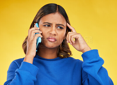 Buy stock photo Confused, phone call and young woman in a studio with an unsure, doubt or thinking facial expression. Technology, remember and Indian female model on a mobile conversation by a yellow background.