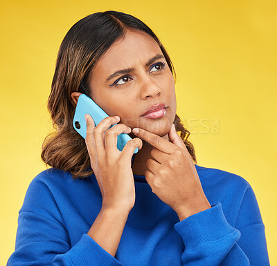 Buy stock photo Phone call, thinking and woman confused, doubt and communication on a yellow studio background. Person, network and model with a smartphone, connection and spam problem with scam and conversation