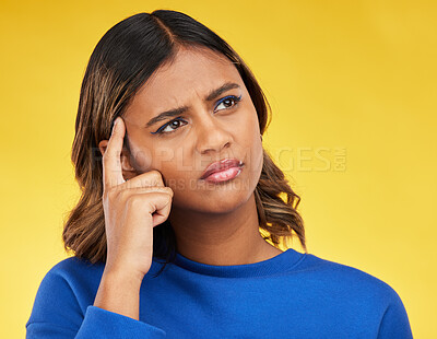 Buy stock photo Thinking, confused and young woman in a studio with a dreaming, idea or brainstorming facial expression. Unsure, doubt and Indian female model with a planning or decision face by a yellow background.