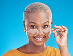 Happy, portrait and black woman with glasses on a blue background for stylish, trendy and fashion. Cool, smile and headshot of an African girl or optometry model with eyewear for vision and eye care