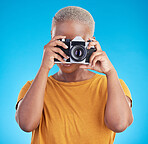 Photographer woman, retro camera and studio for journalist job, art or photoshoot by blue background. African girl, lens and tech for creativity, production or content creation for paparazzi magazine