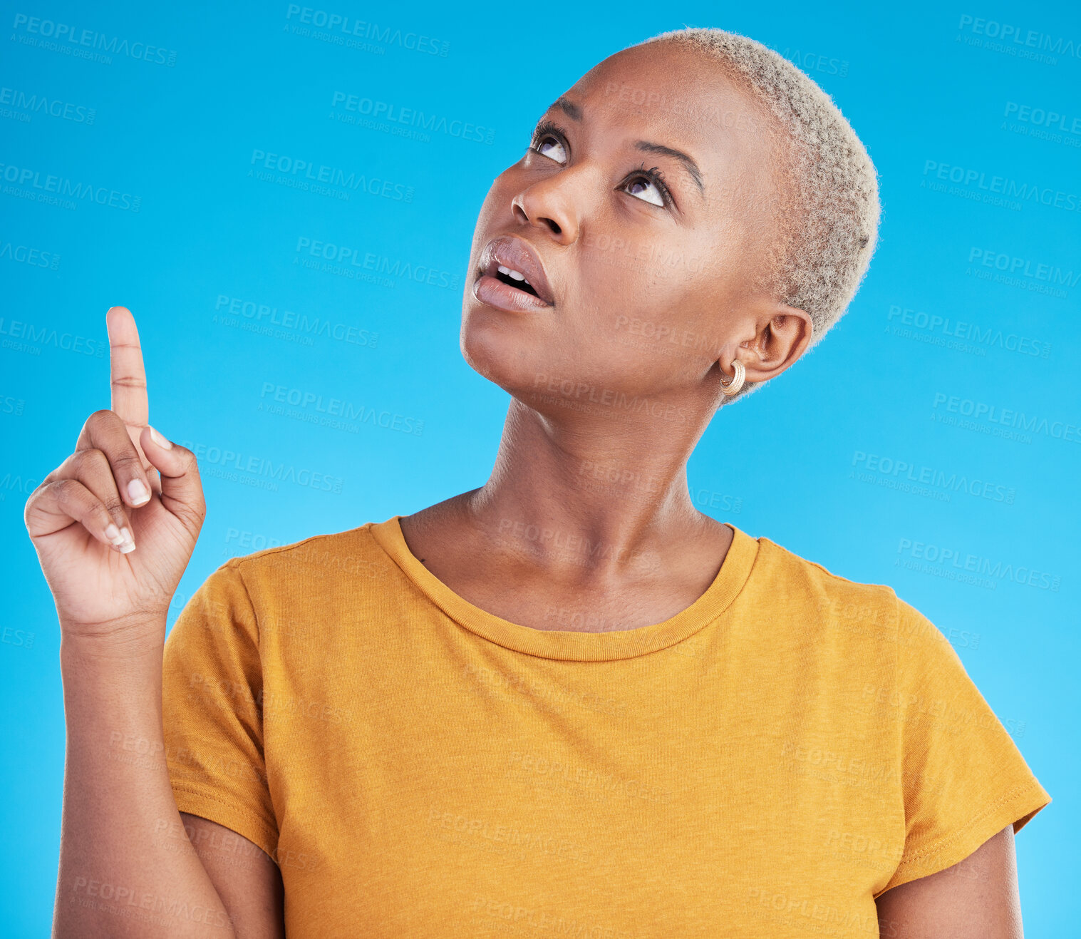 Buy stock photo Pointing up, discount or black woman in studio for mockup space, sale news or product offer on blue background. Doubt, confused or unsure person looking at a promotion, announcement or retail deal