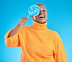Funny, lollipop and portrait of black woman with candy in studio isolated on a blue background. African person, happy face and sweets, dessert and treats, sugar food and eating, laughing and hungry