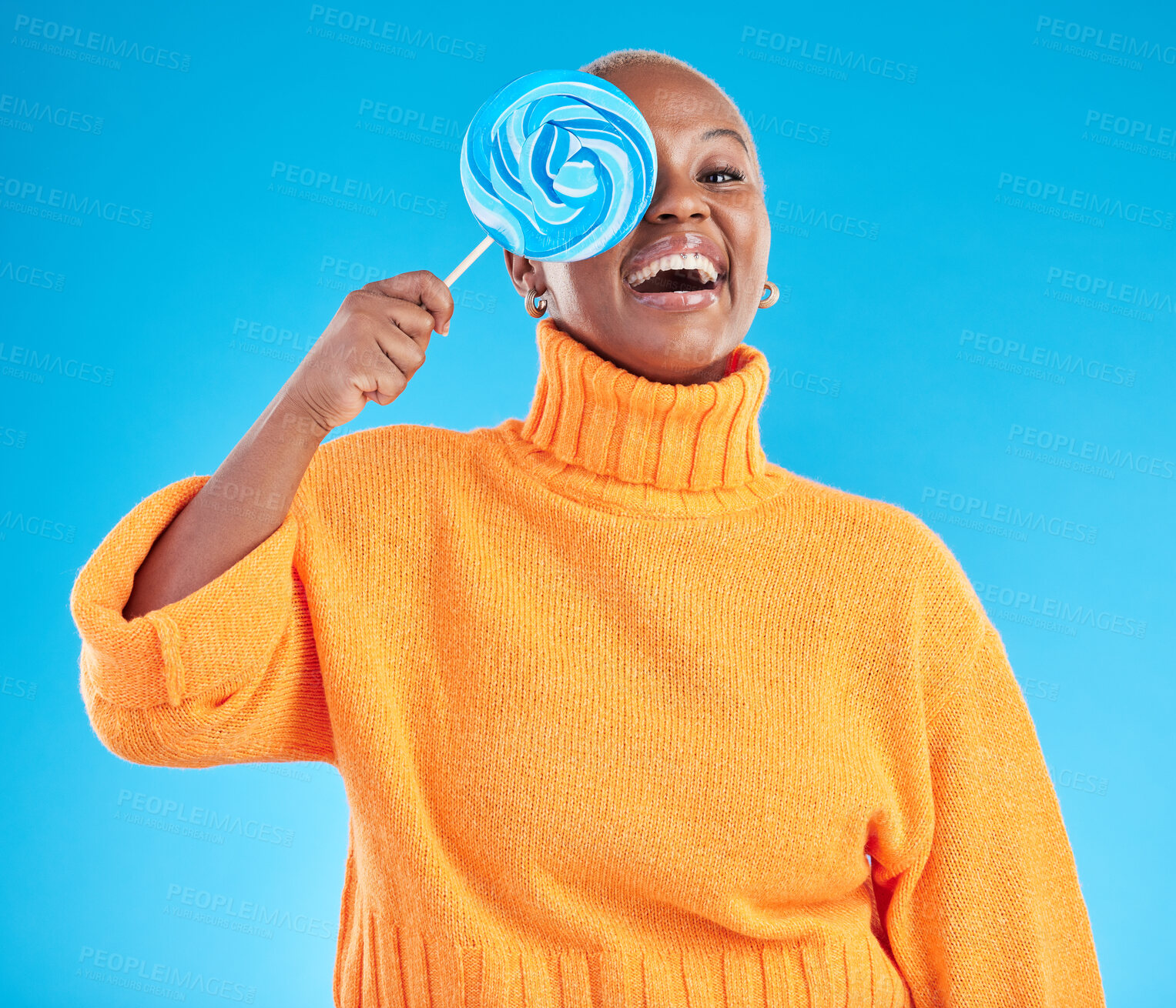 Buy stock photo Funny, lollipop and portrait of black woman with candy in studio isolated on a blue background. African person, happy face and sweets, dessert and treats, sugar food and eating, laughing and hungry