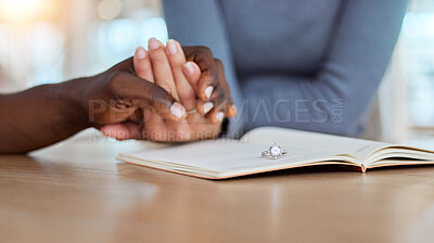 Buy stock photo Closeup, holding hands and book with ring, marriage counseling and couple with support, therapy or help. People, relationship development and mental health with jewellery, prayer and faith in home