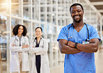 Happy black man, portrait and doctor with arms crossed for medical services, advice and consulting in busy hospital. Surgeon, male nurse and healthcare therapist for expert, trust and pride in clinic