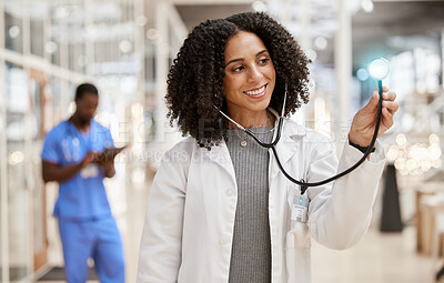 Buy stock photo Woman, doctor and stethoscope with thinking, hospital and smile for check, overlay and light in corridor. African medic, tools and happy for healthcare job, service and listening with glow in clinic