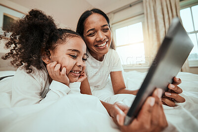 Buy stock photo Mother watching a film on a tablet with her kid in the bed to relax, rest and bond together Happy, smile and young mom streaming movie or video on social media on digital technology with kid at home.