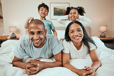 Buy stock photo Happy family, portrait and bonding in bed, having fun and playing in their home together. Face, smile and children with goofy, expression and parents in a bedroom playful, games and enjoying weekend