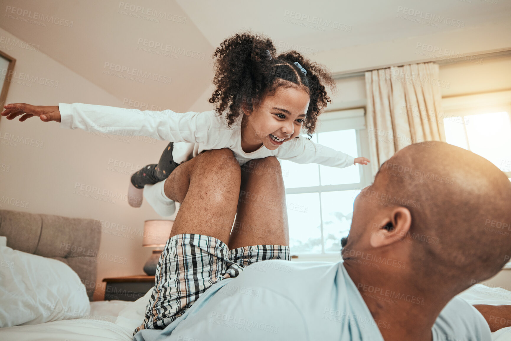 Buy stock photo Dad, child and playing airplane on bed flying for fun, quality time or bonding together in home, bedroom or girl in the air. Happy, father and daughter balance on knees with arms raised and freedom