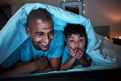 Buy stock photo Night, streaming and father with child in a bed for movie, file or subscription entertainment in their home. Television, watching and parent with boy kid in a bedroom bond, happy and having fun 