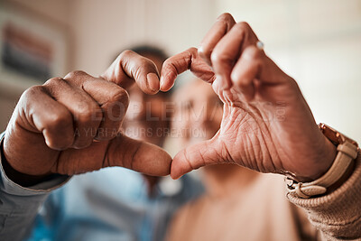 Buy stock photo Senior couple, heart shape and hands at home with love, happiness and care. Man and woman relax together with icon, symbol or emoji for commitment, marriage and trust or support on valentines day
