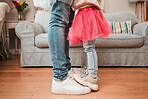 Dance, support and shoes of father and daughter in living room for ballet, princess and love. Music, care and learning with closeup of man and child in family home for helping, youth and energy 