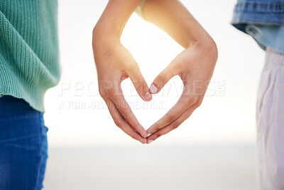 Buy stock photo Closeup, beach and couple with heart hands, marriage and relationship with growth, loving and bonding. Zoom, people and lovers with symbol for love, support and social media with gesture and romance