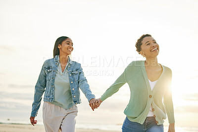 Buy stock photo Love, beach and lesbian couple holding hands, walking together on sand and sunset holiday adventure. Lgbt women, bonding and relax on ocean vacation with romantic date, pride and happy nature travel.