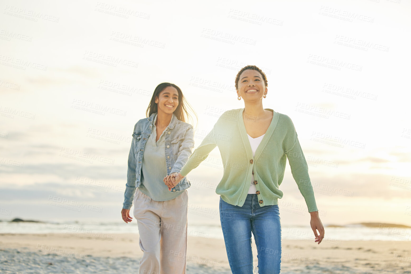 Buy stock photo Love, ocean and lesbian couple holding hands, walking together and summer sunset holiday adventure. Lgbt women, bonding and relax on ocean vacation with romantic date, pride and happy nature travel.