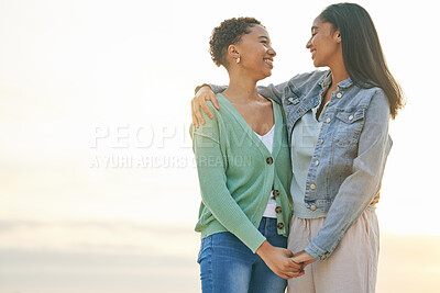 Buy stock photo Love, beach and mockup, lesbian couple hug and holding hands together on sunset holiday adventure. Lgbt women, bonding and relax on ocean vacation with romantic date, pride and happy nature travel.