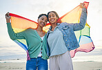 Woman, lesbian couple and pride flag on beach together in happiness for LGBTQ community or rights. Portrait of proud and confident gay or bisexual women smile on ocean coast in love, support or trust