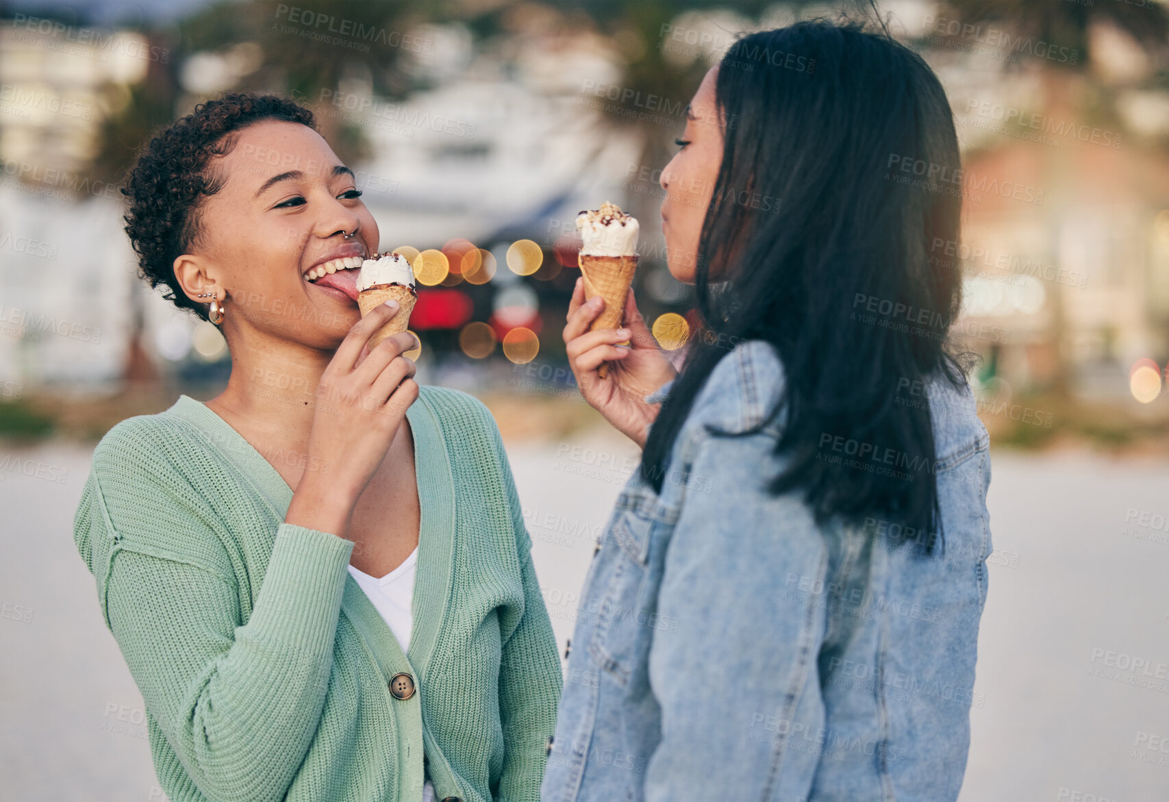 Buy stock photo Ice cream, beach and lesbian couple eating dessert in sunset together on an outdoor vacation or holiday for romance. Lgbtq, pride and women bonding on a summer date for love, relax and happiness